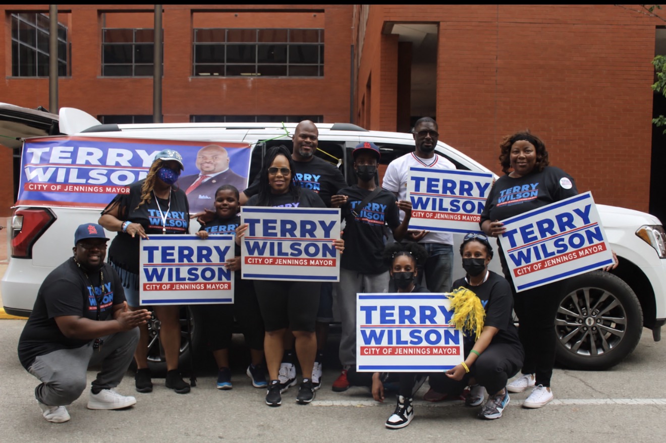 Terry Wilson with a group holding Terry Wilson campaign signs